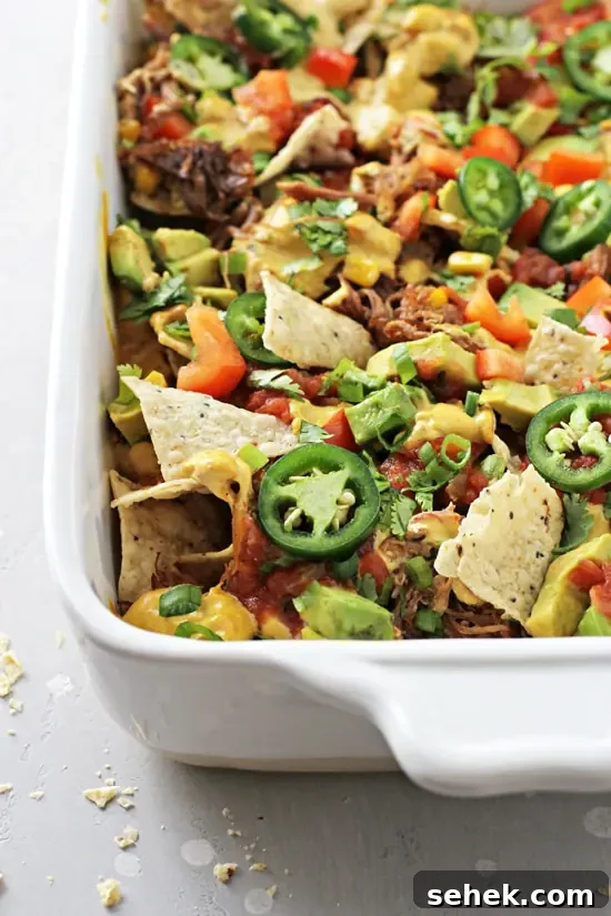 Dairy-Free Nachos Recipe: Crispy, Cheesy Vegan Nachos 5 Non Dairy Nachos in a white baking dish.