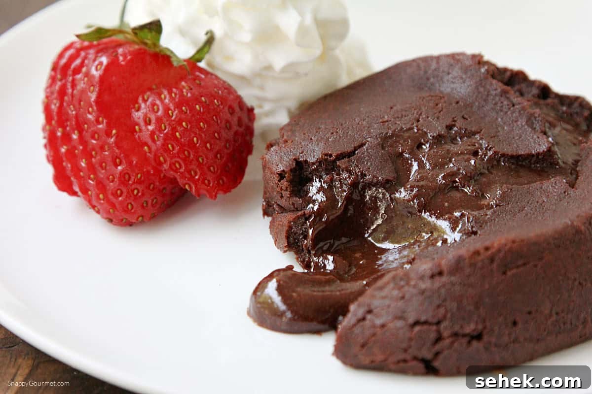Chocolate Molten Lava Cake Chocolate Molten Lava Cake on plate with strawberry and whipped cream