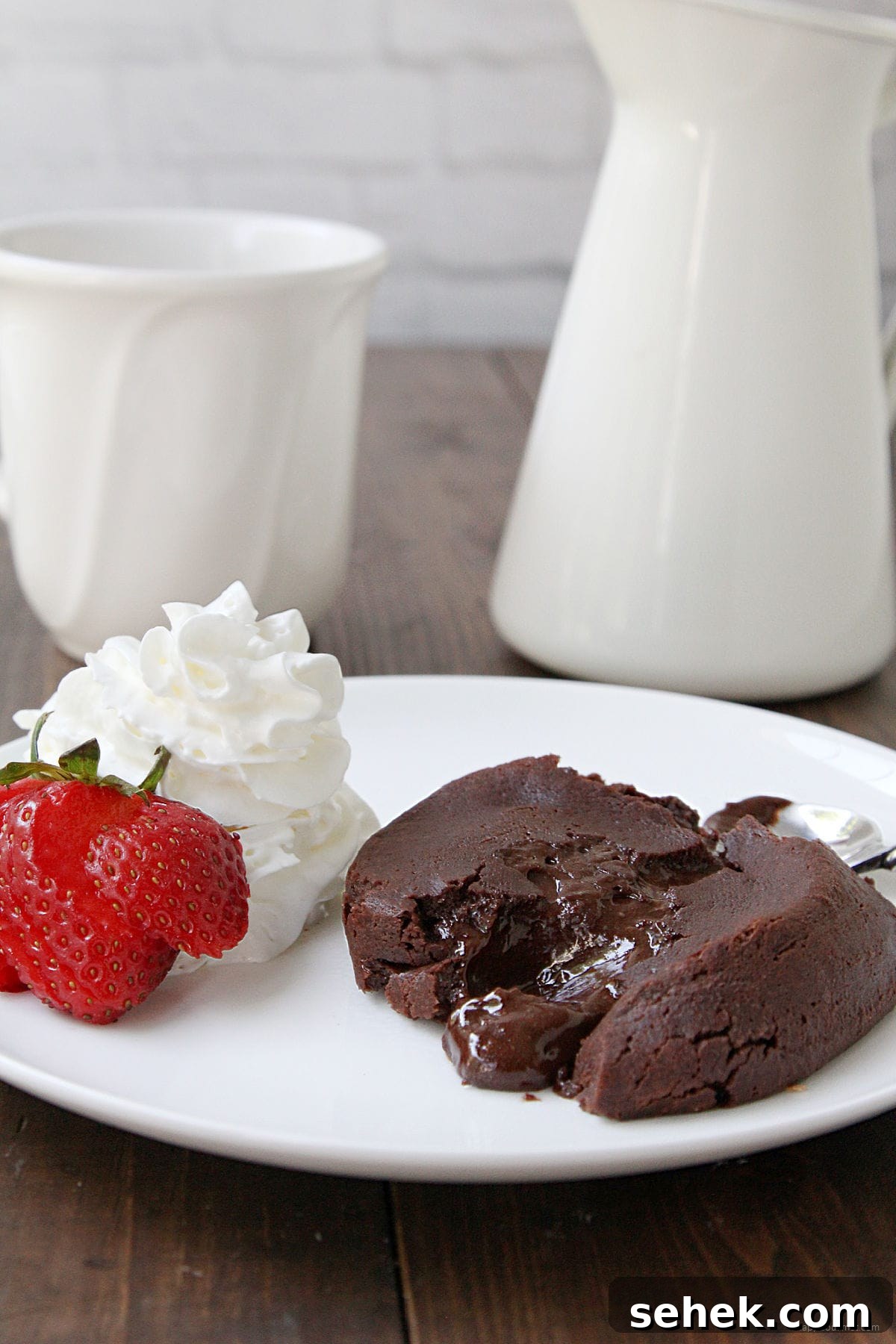 Chocolate Molten Lava Cake Chocolate Molten Lava Cake on plate with strawberry and whip cream