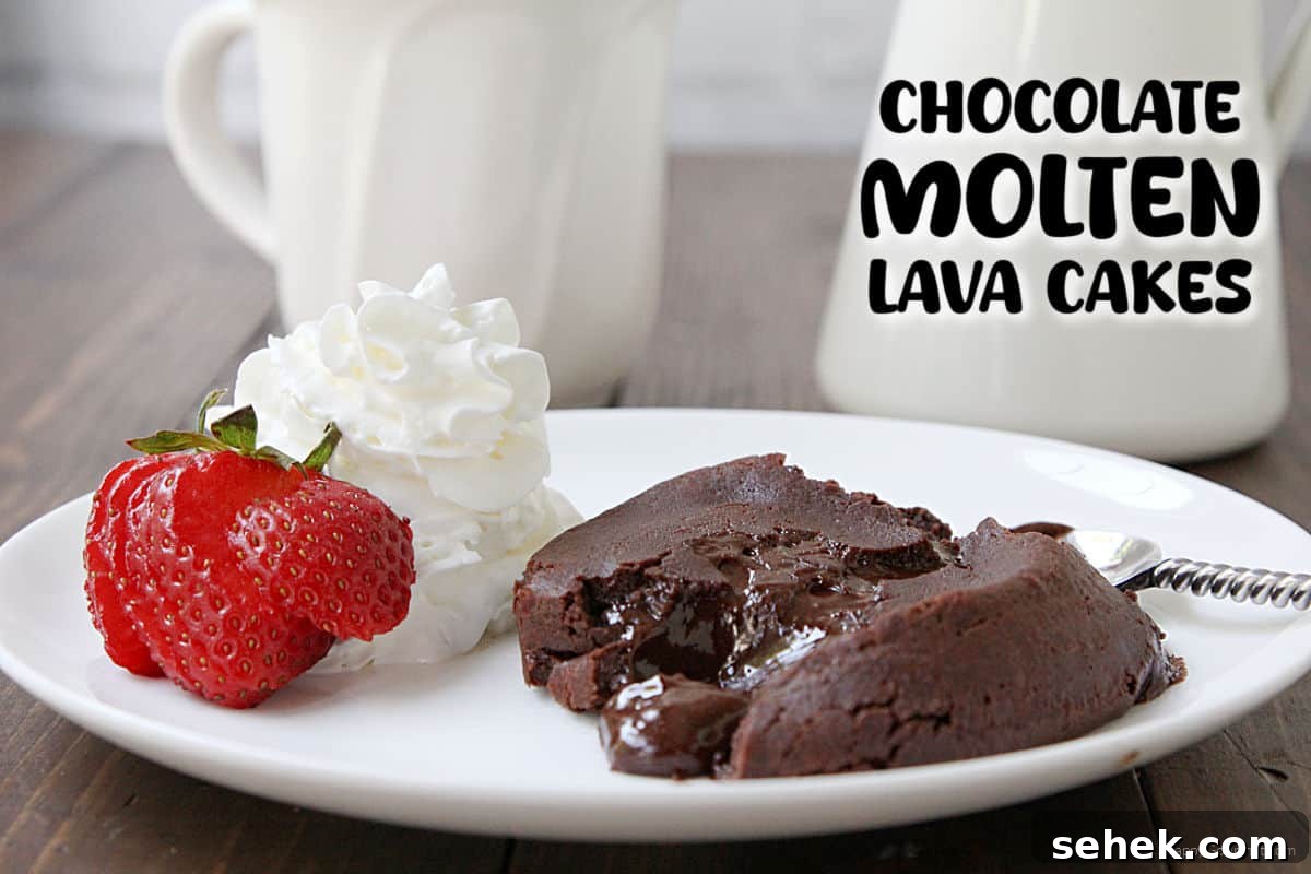Chocolate Molten Lava Cake Chocolate Molten Lava Cake on plate with spoon, strawberry and whipped cream and coffee mug in back