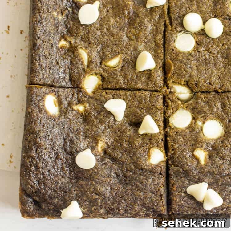 Chewy Matcha Blondies with White Chocolate Swirls 12 close up of white chocolate matcha blondies cut into squares