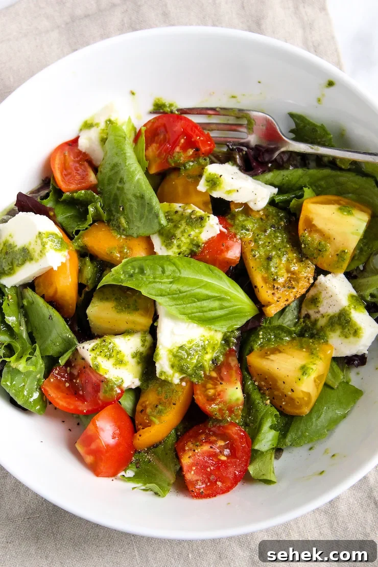 Caprese Salad with Fresh Basil Vinaigrette 6 Caprese salad in white bowl.