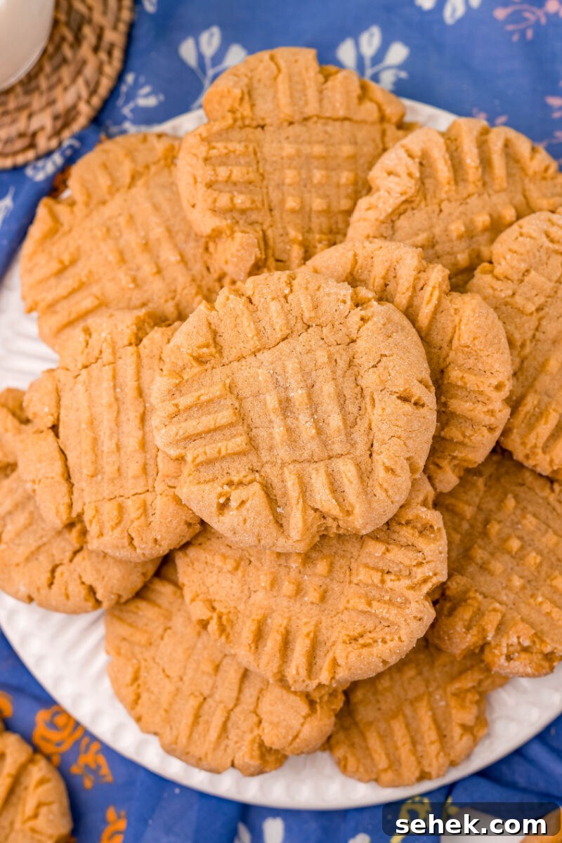 Chewy Peanut Butter Cookies with Crispy Edges: Simple Recipe 2 looking down at a white plate with a pile on peanut butter cookies