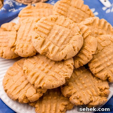 Chewy Peanut Butter Cookies with Crispy Edges: Simple Recipe 11 square image of peanut butter cookies piled on a plate