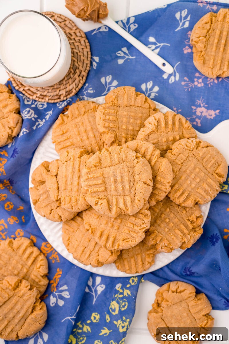 Chewy Peanut Butter Cookies with Crispy Edges: Simple Recipe 9 looking down at a plate of peanut butter cookies next to a glass of milk