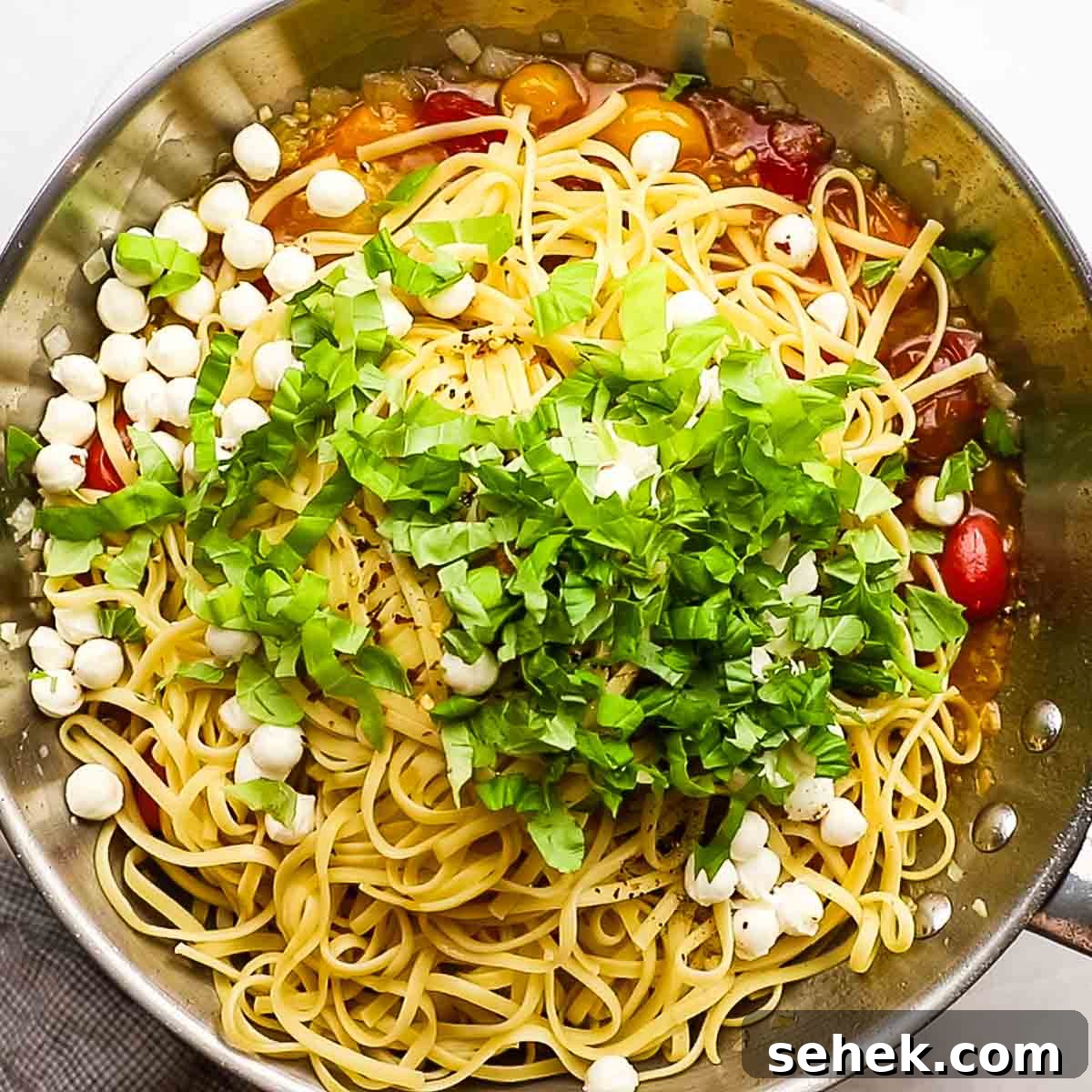 Quick Cherry Tomato Pasta with Garlic and Basil 10 pasta, basil, and mozzarella balls added to the skillet with the tomato sauce