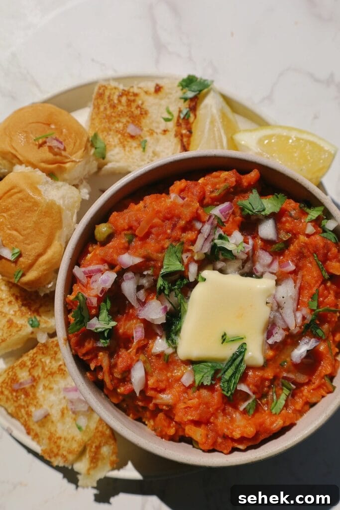 Authentic Mumbai Pav Bhaji Recipe: Flavorful Street-Style Masala 3 pav bhaji with butter on top