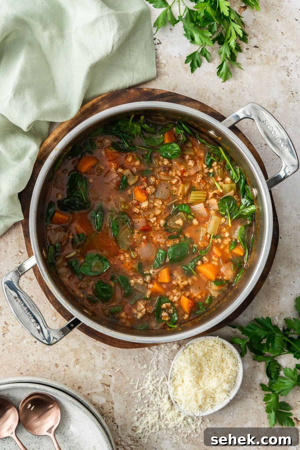 Mediterranean Barley Vegetable Soup Recipe for Flavorful Comfort 4 Pot of Mediterranean Vegetable and Barley Soup sitting on a round wooden board.