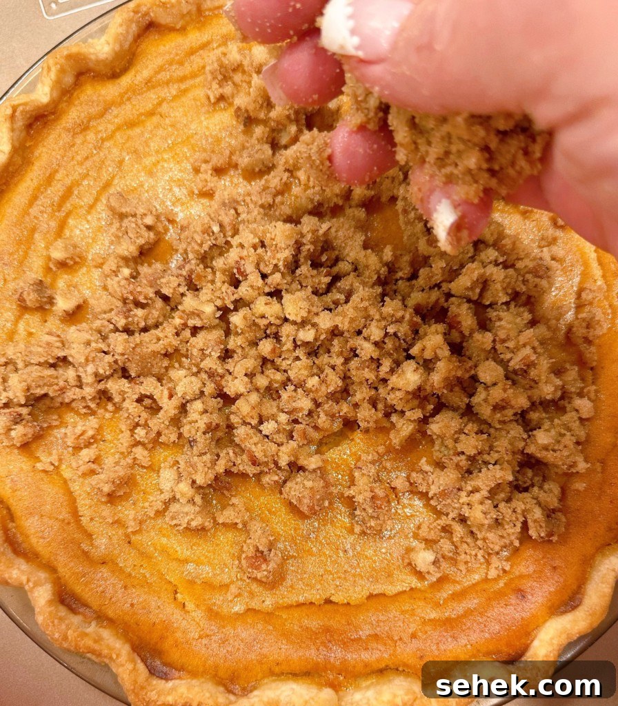 Sweet Potato Pecan Pie: Classic Holiday Dessert Recipe 10 Adding pecan topping to the top of the sweet potato pie.