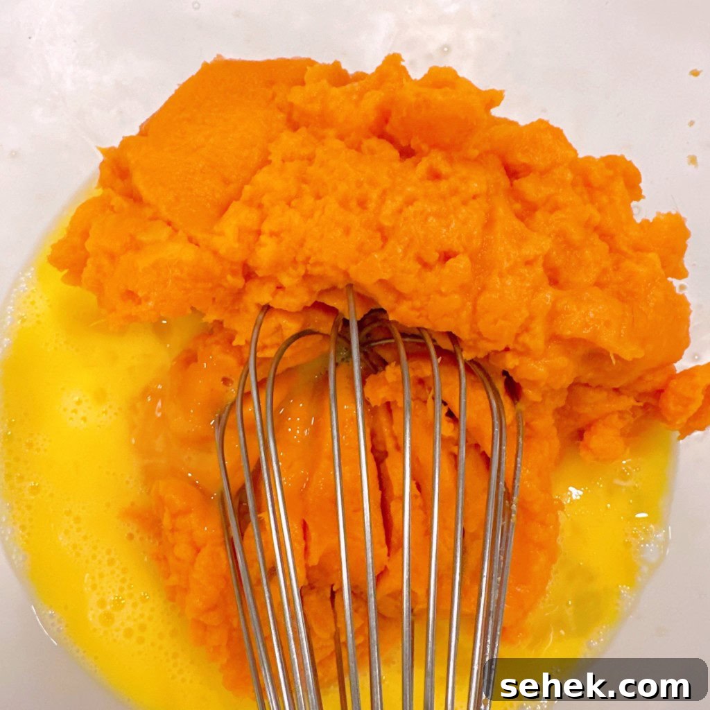 Sweet Potato Pecan Pie: Classic Holiday Dessert Recipe 5 Combining Sweet potatoes with eggs.