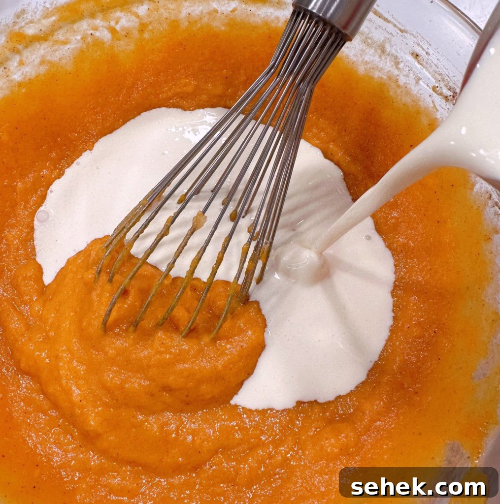 Sweet Potato Pecan Pie: Classic Holiday Dessert Recipe 6 Adding cream to sweet potato filling.