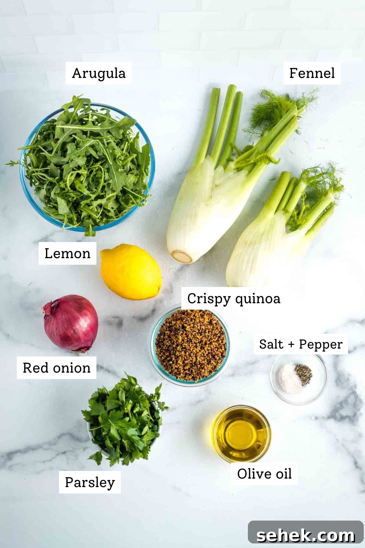 Shaved Fennel & Arugula Salad with Crispy Quinoa Crunch 3 Labeled ingredients: arugula, fennel bulbs, red onion, lemon, parsley, olive oil, salt & pepper, crispy quinoa.
