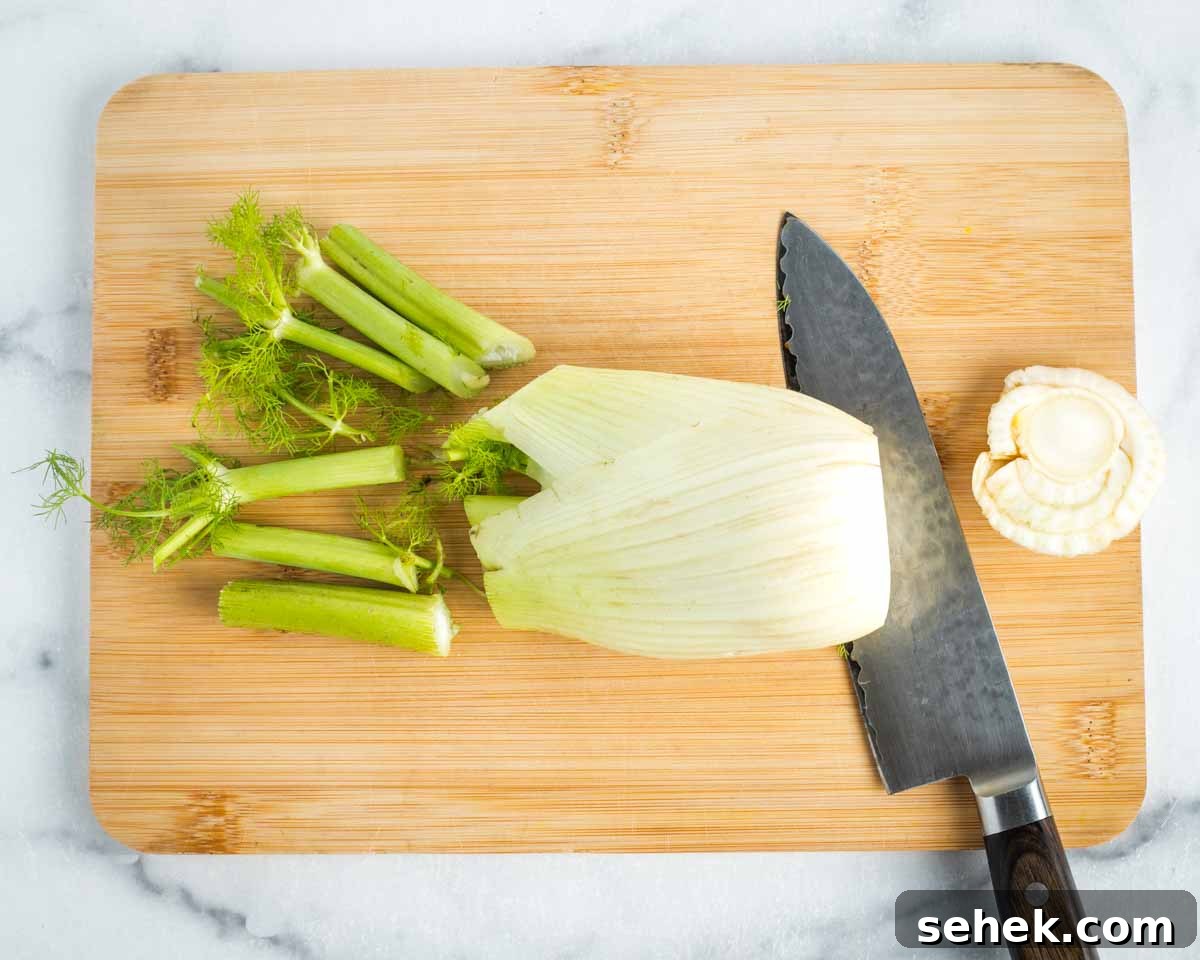 Shaved Fennel & Arugula Salad with Crispy Quinoa Crunch 5 Large bulb of fennel on a cutting board, fronds and root end slices off.