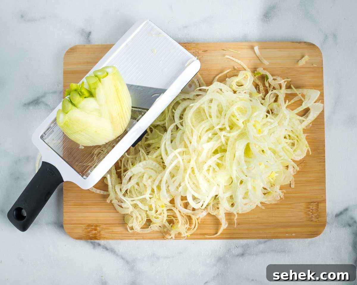 Shaved Fennel & Arugula Salad with Crispy Quinoa Crunch 6 Small handheld mandolin thinly slicing bulb of fennel.