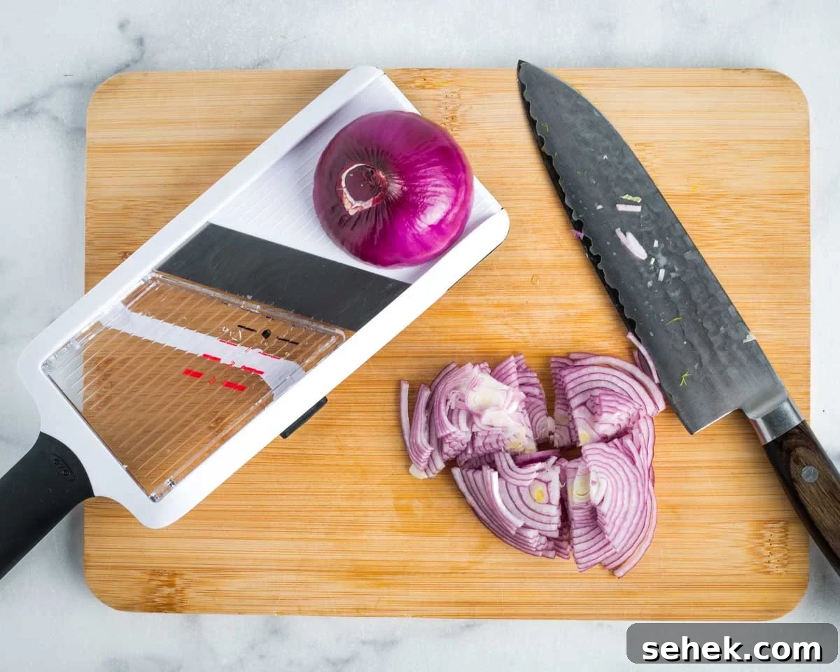 Shaved Fennel & Arugula Salad with Crispy Quinoa Crunch 7 Thinly sliced red onion with a mandolin and then cutting those slices into quarters.