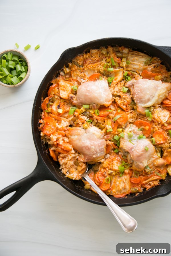 5-Ingredient Gluten-Free Kimchi Chicken Casserole 16 gluten-free chicken casserole in a skillet with a spoon