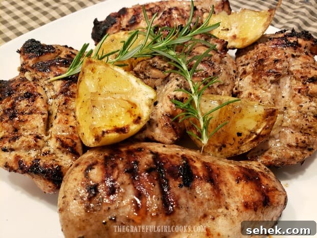 Grilled Lemon Chicken Breasts - The Grateful Girl Cooks! Grilled Lemon Chicken Breasts are served, garnished with charred lemon wedges and rosemary sprigs.