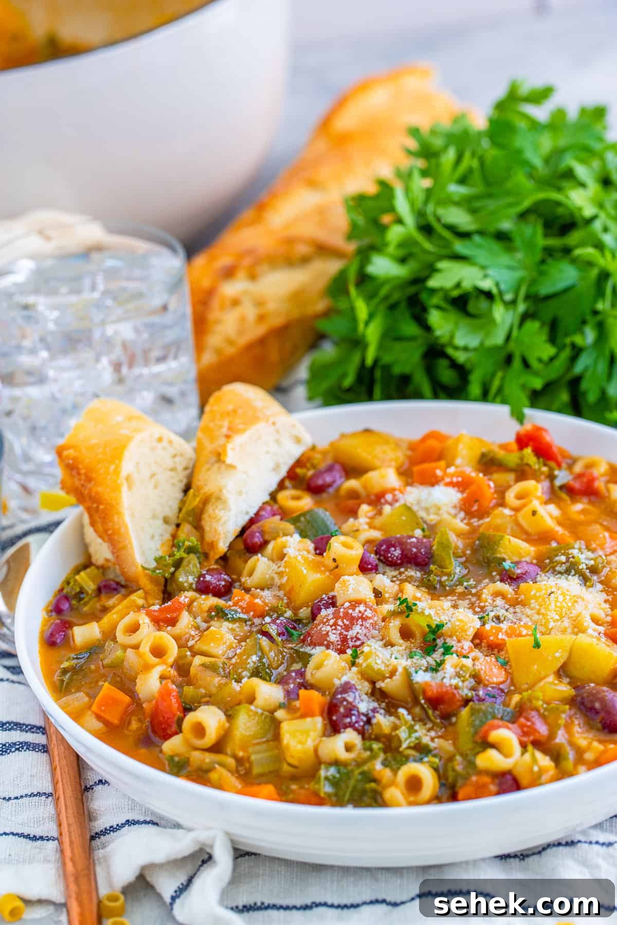 Classic Italian Minestrone Soup Recipe for Homemade Comfort 2 Bowl of soup with slices of bread in bowl.