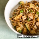 Blackstone Hibachi-Style Chicken Recipe for Grill or Griddle 5 Close up of hibachi noodles with chicken and vegetables.