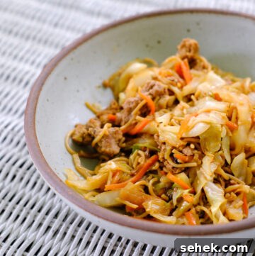 Blackstone Hibachi-Style Chicken Recipe for Grill or Griddle 4 Close up of egg roll in a bowl in a gray bowl.