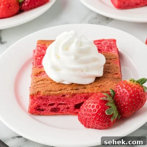 Strawberry angel food cake topped with whipped cream.