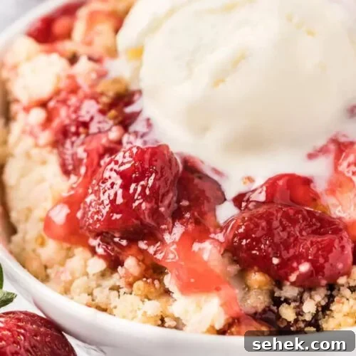 Bowl of strawberry dump cake with ice cream.