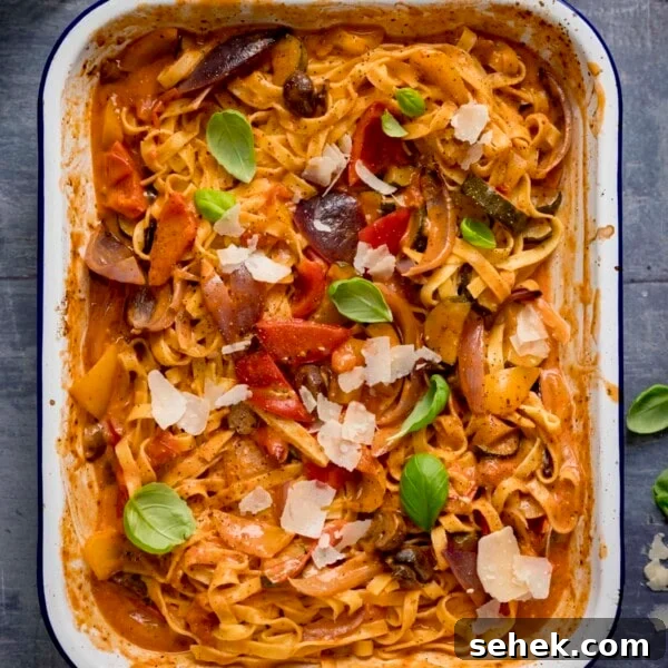 Savory Vegetarian Nut Roast Recipe for Holiday Dinner 12 Tagliatelle in a creamy roasted vegetable sauce in a white roasting tin.