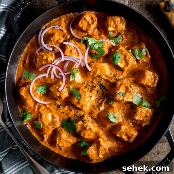 Savory Vegetarian Nut Roast Recipe for Holiday Dinner 13 Overhead picture of a paneer curry in a black pan sprinkled with coriander.
