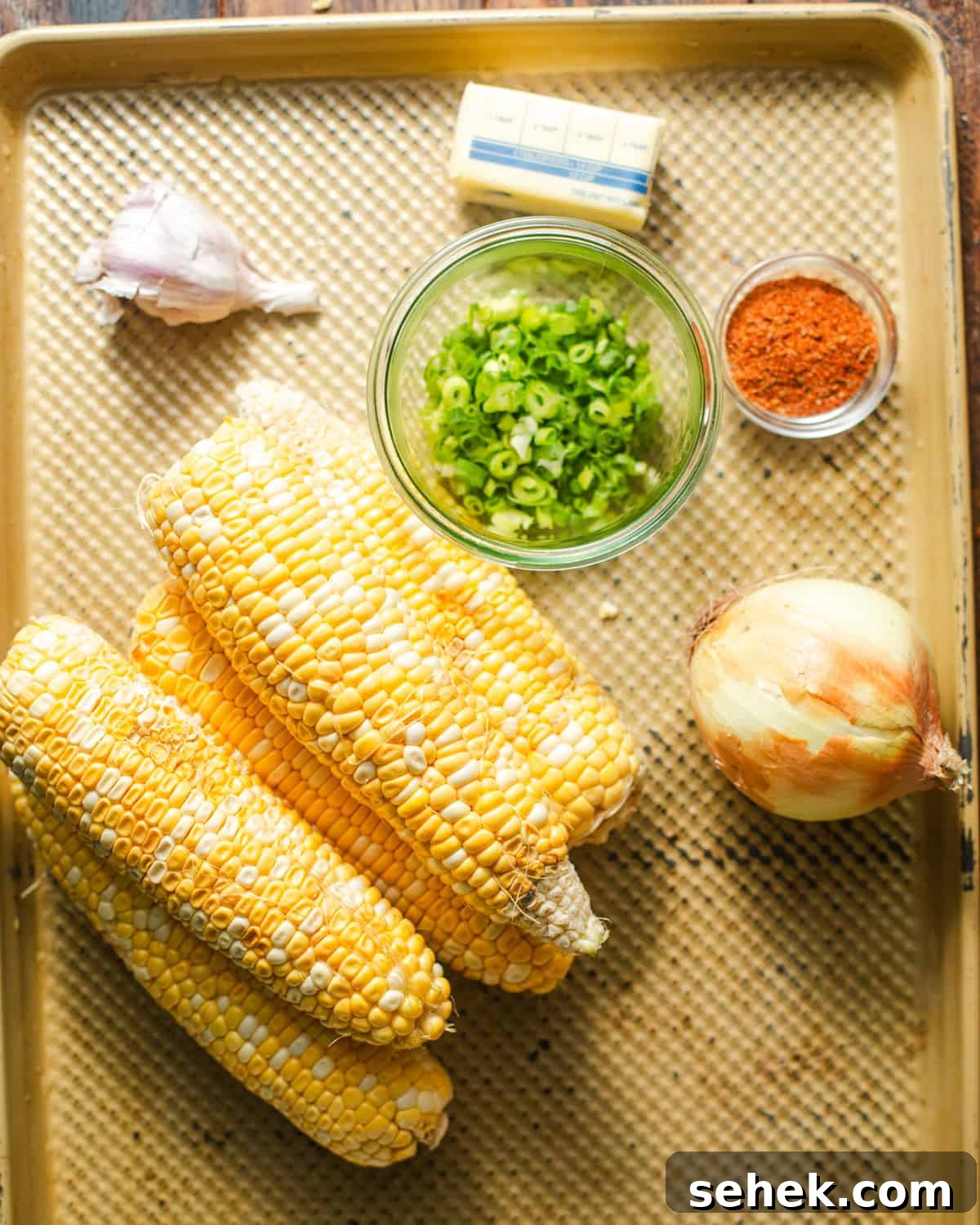 Smoky Blackened Corn with Chili-Lime Butter 3 ingredients to make blackened corn - fresh corn, scallions, blackened seasoning, onion, garlic, butter, and brown sugar.