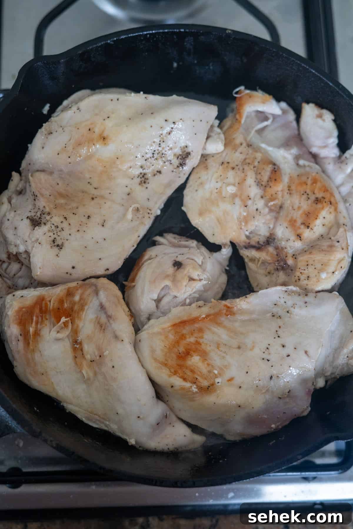 Creamy Tarragon Chicken Skillet with Lemon and Garlic 4 Tarragon chicken breasts in a skillet on a stove top.