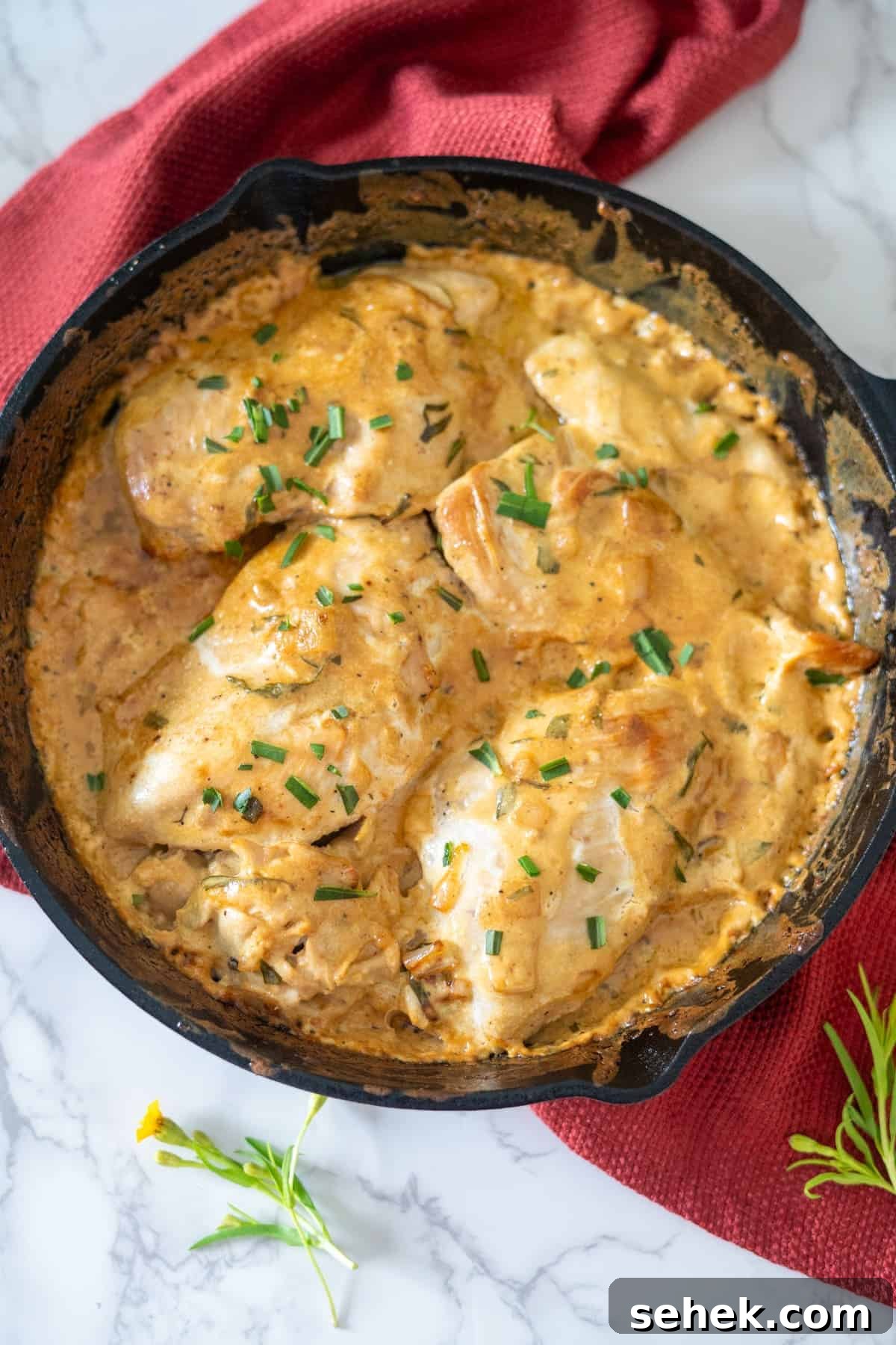 Creamy Tarragon Chicken Skillet with Lemon and Garlic 8 Tarragon chicken breasts cooked in a skillet with sauce and herbs.