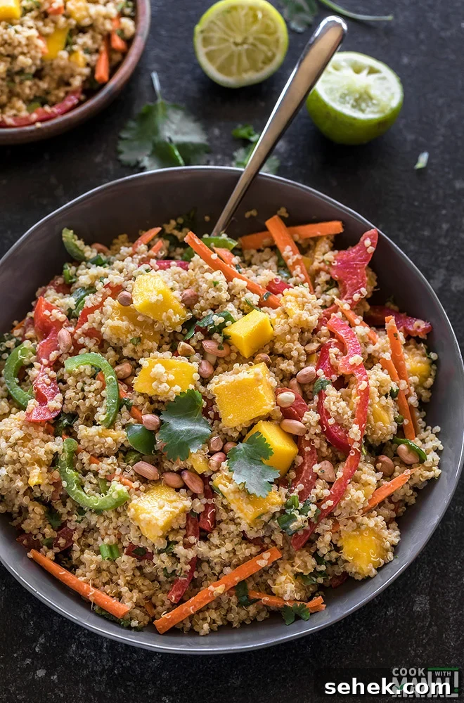 Thai Quinoa Mango Salad with Peanut Ginger Dressing 3 quinoa mango salad in a grey bowl with a spoon on the side