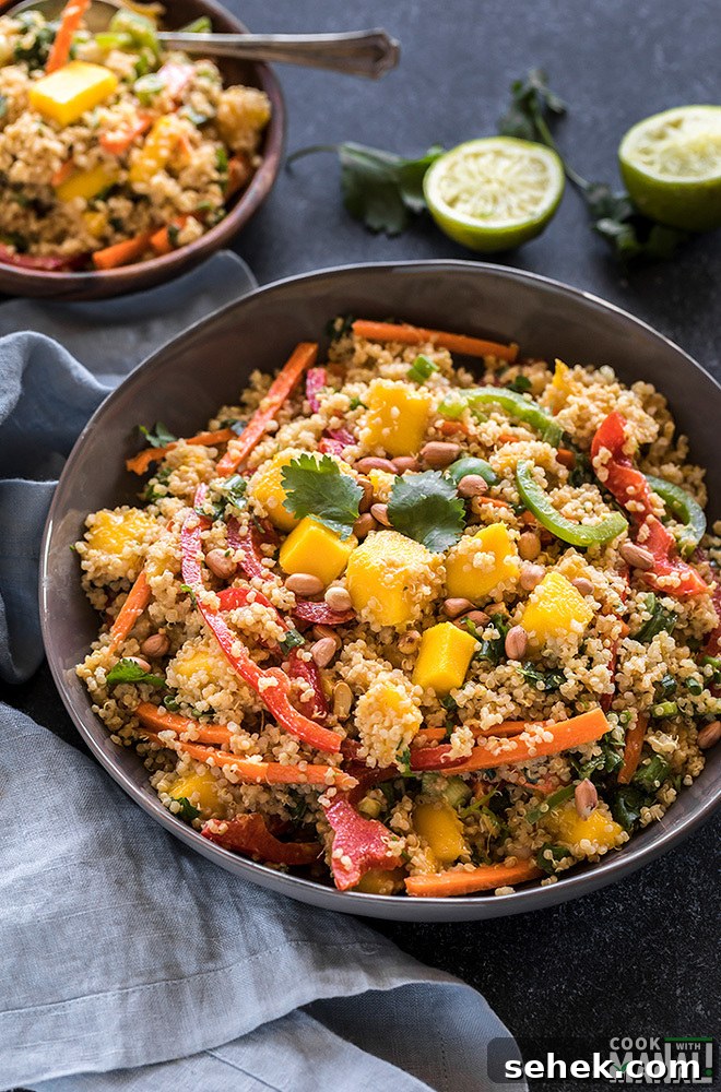 Thai Quinoa Mango Salad with Peanut Ginger Dressing 4 quinoa mango salad in a large grey bowl with a blue napkin on the side and some lime and cilantro in the background