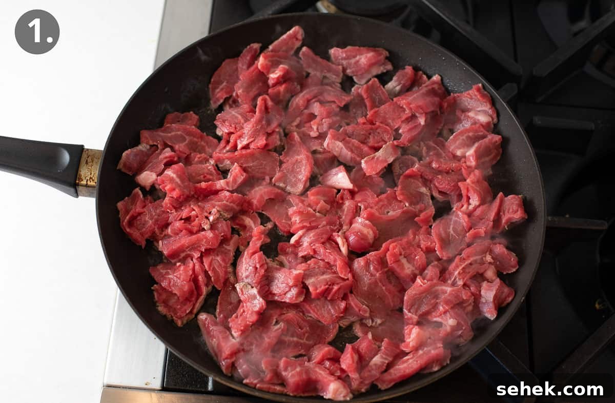 Sizzling Beef Stir-Fry with Shredded Vegetables and Ginger 4 Raw beef in a skillet