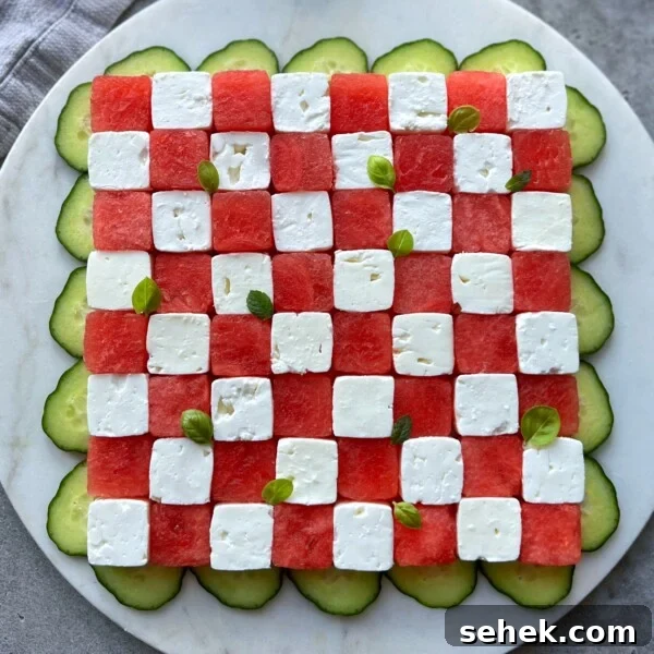 Classic Tomato Caprese Salad with Fresh Basil and Mozzarella 6 A square salad arranged like a checkerboard with alternating cubes of watermelon and feta, garnished with small basil leaves, and surrounded by overlapping cucumber slices on a round white plate—perfect for fresh, healthy bites.