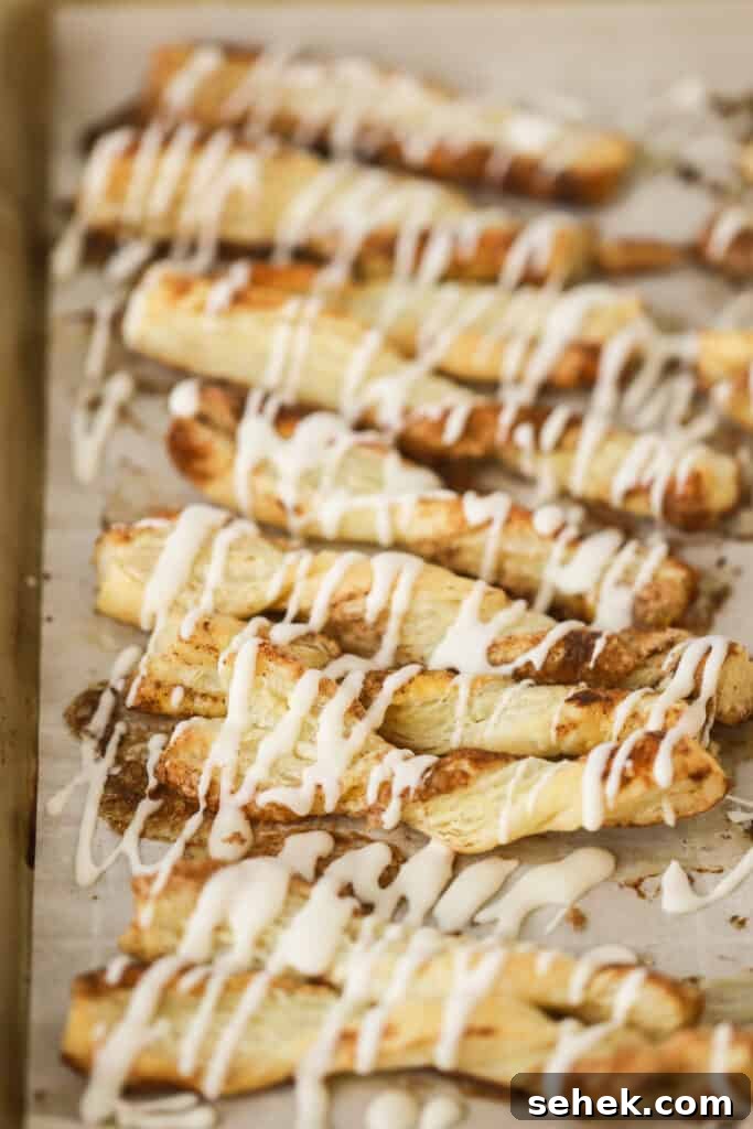 Crispy Cinnamon Puff Pastry Twists: Quick Sweet Pastry Recipe 3 Cinnamon Twists (puff pastry) drizzled with icing on a baking sheet.