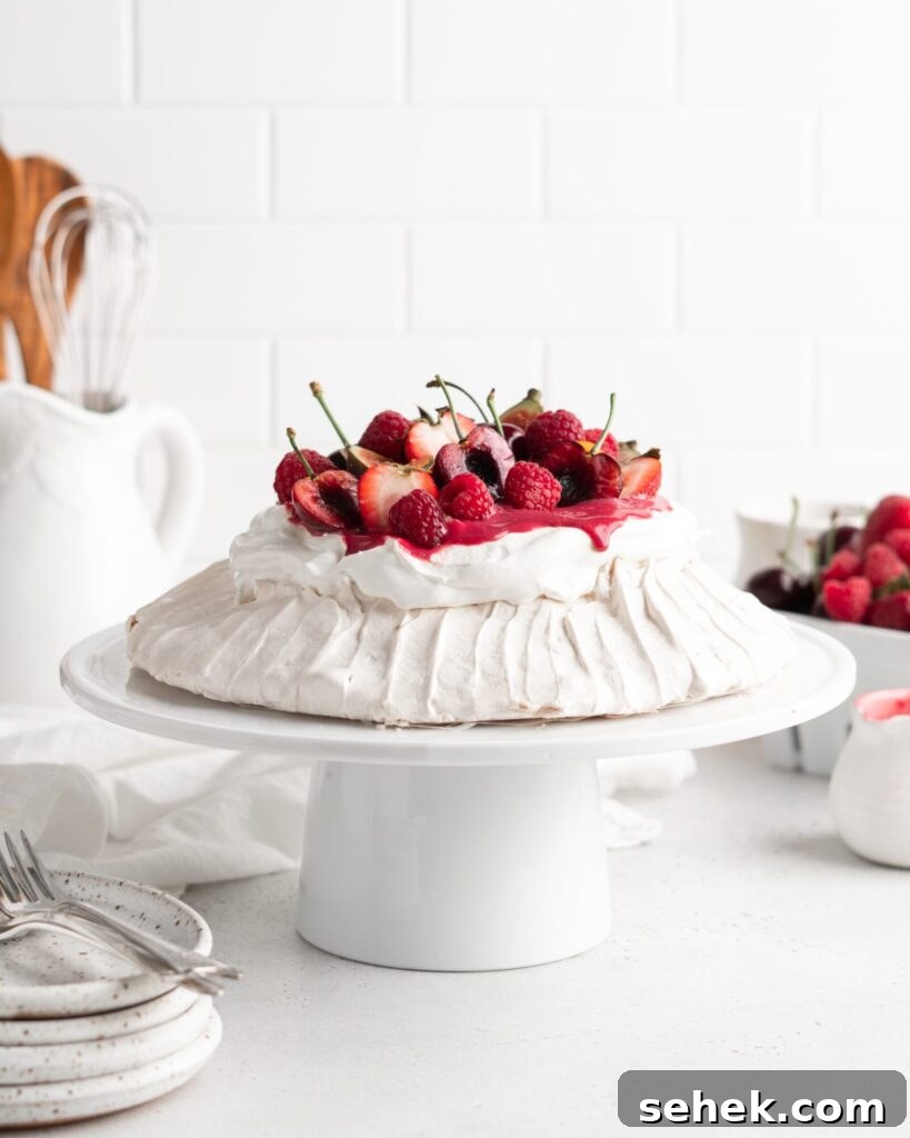 Summer Berry Pavlova Recipe with Whipped Cream and Vanilla 2 Fluffy and delicious Pavlova is topped with raspberry curd, fresh whipped cream, and loads of summer berries.