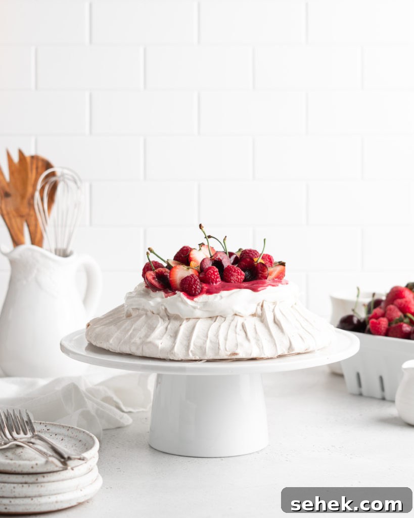 Summer Berry Pavlova Recipe with Whipped Cream and Vanilla 3 Fluffy and delicious Pavlova is topped with raspberry curd, fresh whipped cream, and loads of summer berries.