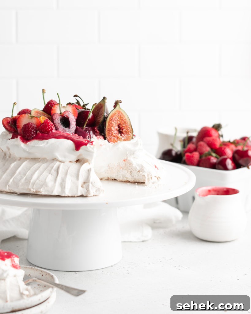 Summer Berry Pavlova Recipe with Whipped Cream and Vanilla 4 Fluffy and delicious Pavlova is topped with raspberry curd, fresh whipped cream, and loads of summer berries.