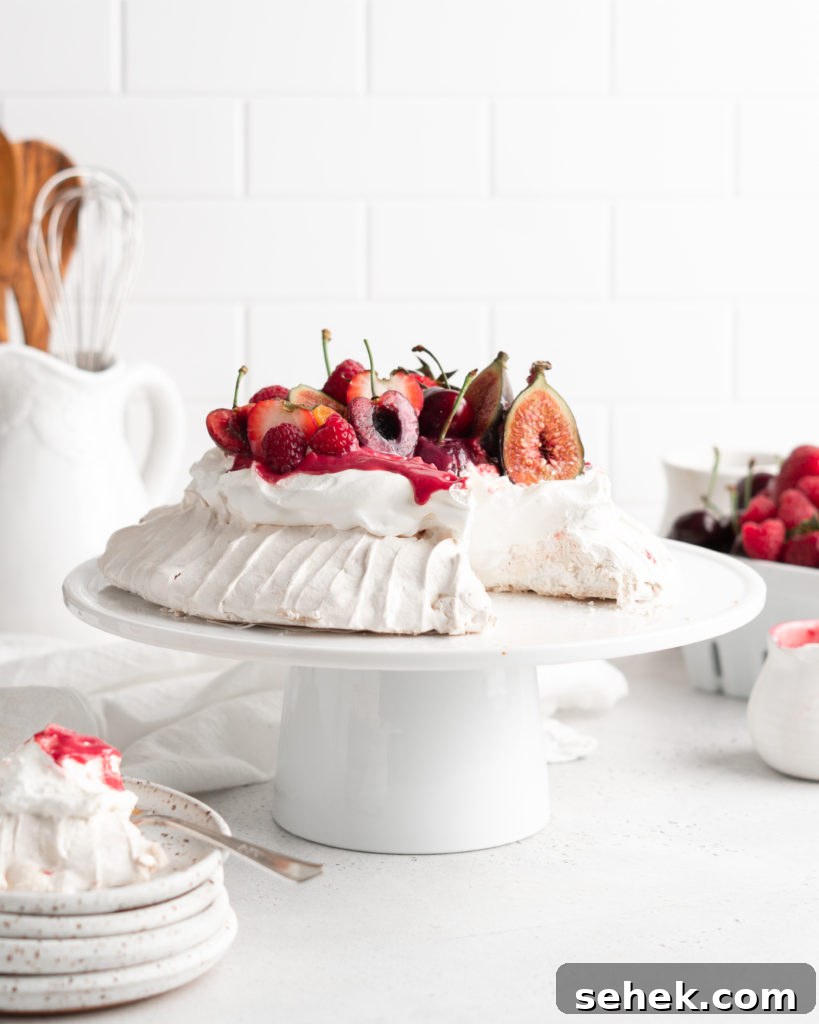 Summer Berry Pavlova Recipe with Whipped Cream and Vanilla 5 Fluffy and delicious Pavlova is topped with raspberry curd, fresh whipped cream, and loads of summer berries.