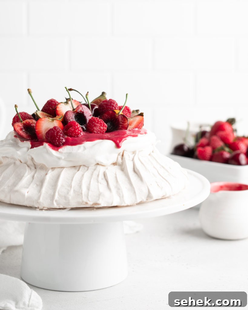 Summer Berry Pavlova Recipe with Whipped Cream and Vanilla 6 Fluffy and delicious Pavlova is topped with raspberry curd, fresh whipped cream, and loads of summer berries.