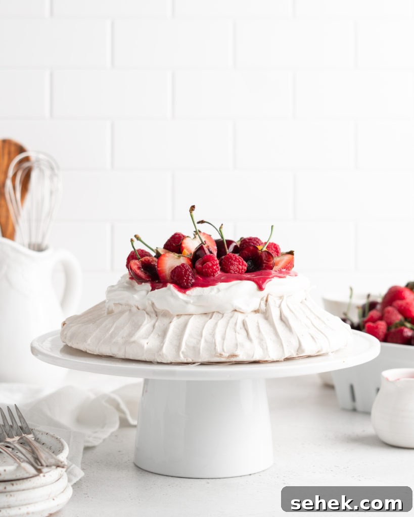 Summer Berry Pavlova Recipe with Whipped Cream and Vanilla 7 Fluffy and delicious Pavlova is topped with raspberry curd, fresh whipped cream, and loads of summer berries.