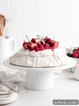 Summer Berry Pavlova Recipe with Whipped Cream and Vanilla 8 Fluffy and delicious Pavlova is topped with raspberry curd, fresh whipped cream, and loads of summer berries.