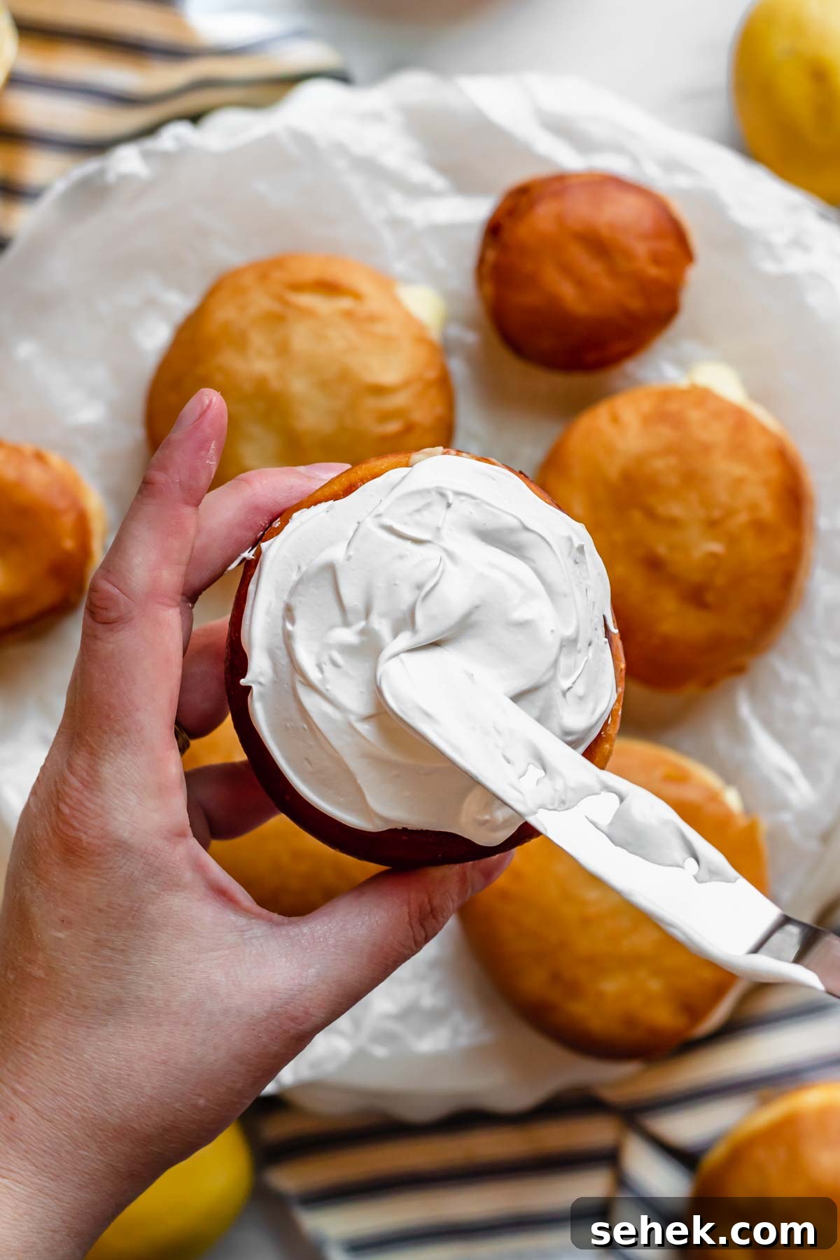 Lemon Meringue-Filled Donuts: Zesty Citrus Cream Puff 15 Swiss meringue gets added to the top of the donut with a spatula.
