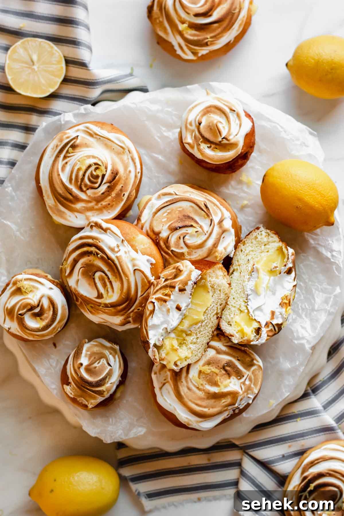 Lemon Meringue-Filled Donuts: Zesty Citrus Cream Puff 16 An array of lemon filled donuts, some normal and some mini.