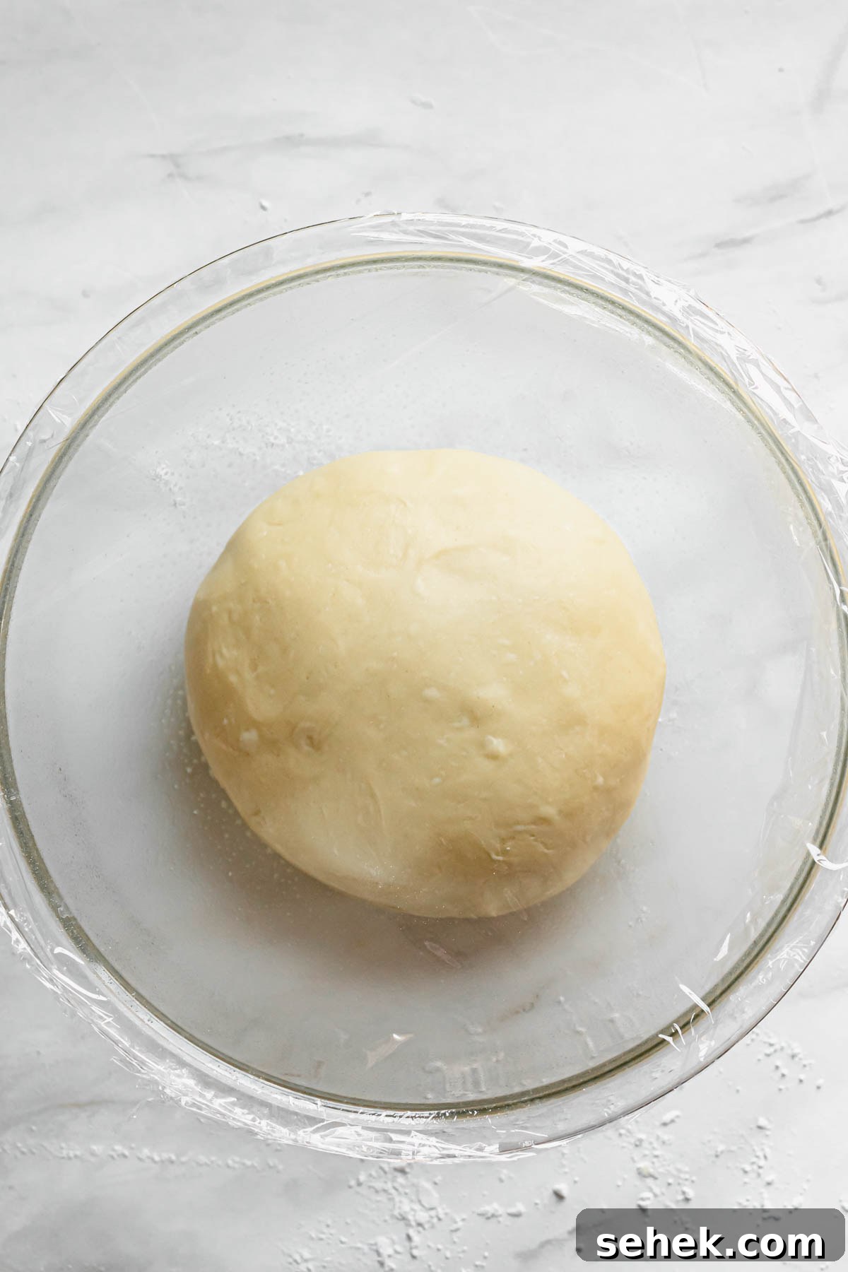 Lemon Meringue-Filled Donuts: Zesty Citrus Cream Puff 6 Dough is added to a bowl after kneading and reading to start the first rise.
