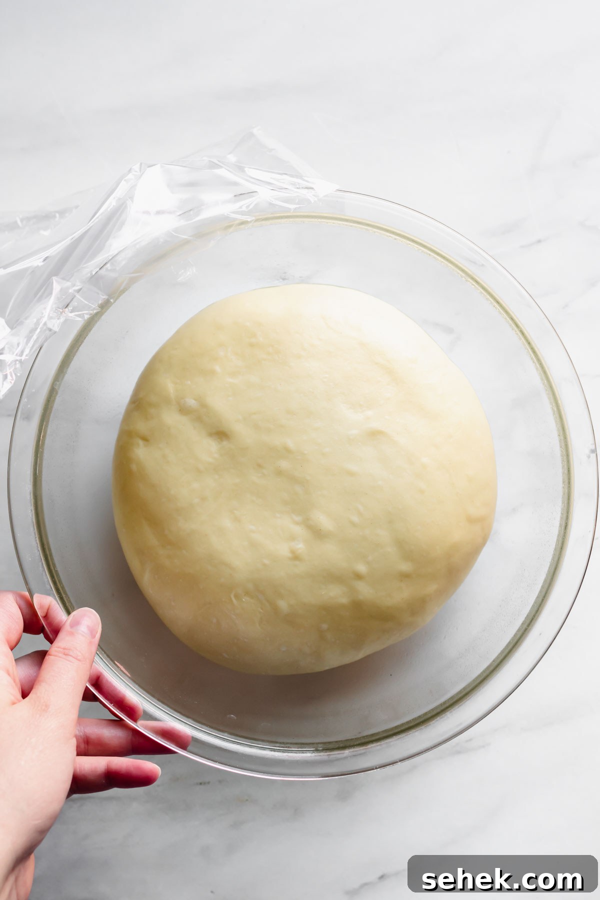 Lemon Meringue-Filled Donuts: Zesty Citrus Cream Puff 7 Donut dough in the bowl has doubled in size and is ready to roll out.