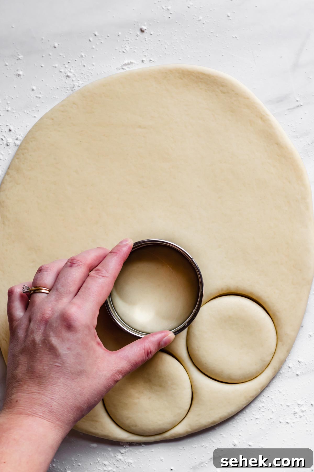 Lemon Meringue-Filled Donuts: Zesty Citrus Cream Puff 8 A cookie cutter is used to stamp out donuts from the rolled out dough.