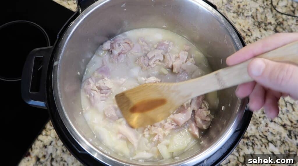 Instant Pot Nashville Hot Chicken with Spiced Rice 13 Making sure rice is submerged in broth in the pot