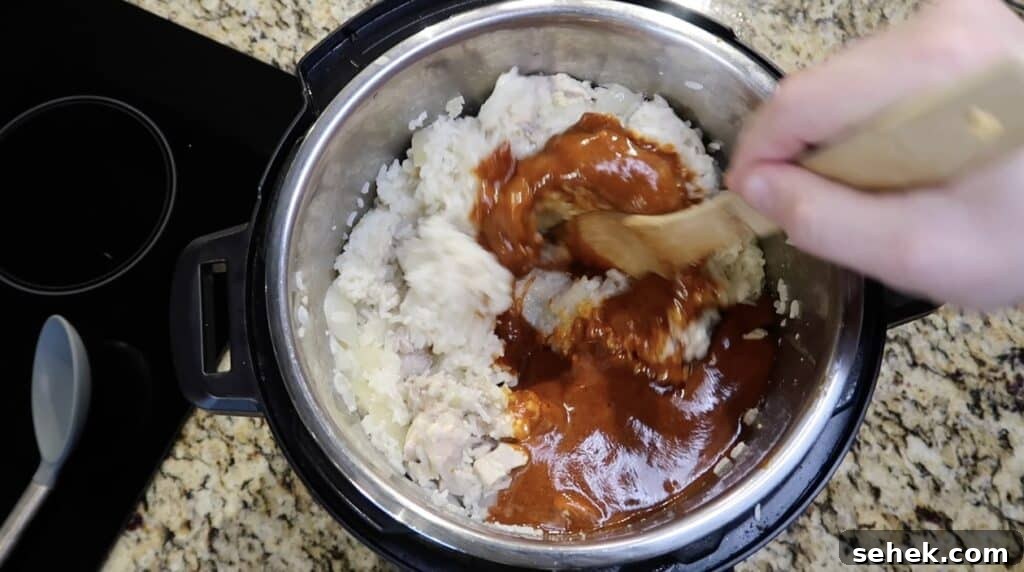 Instant Pot Nashville Hot Chicken with Spiced Rice 18 Stirring sauce into chicken and rice